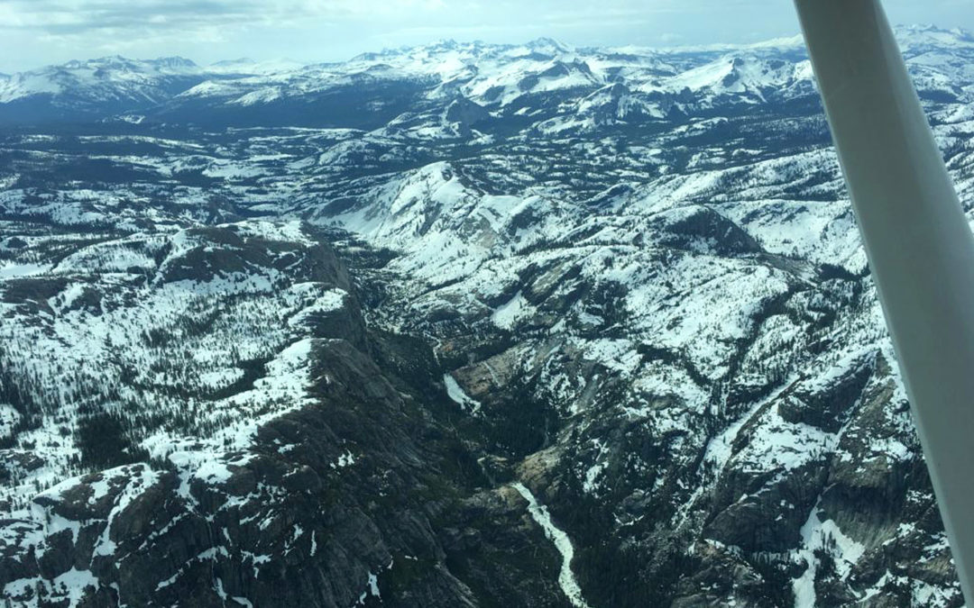 Snow melting into water below Tuolumne Meadows